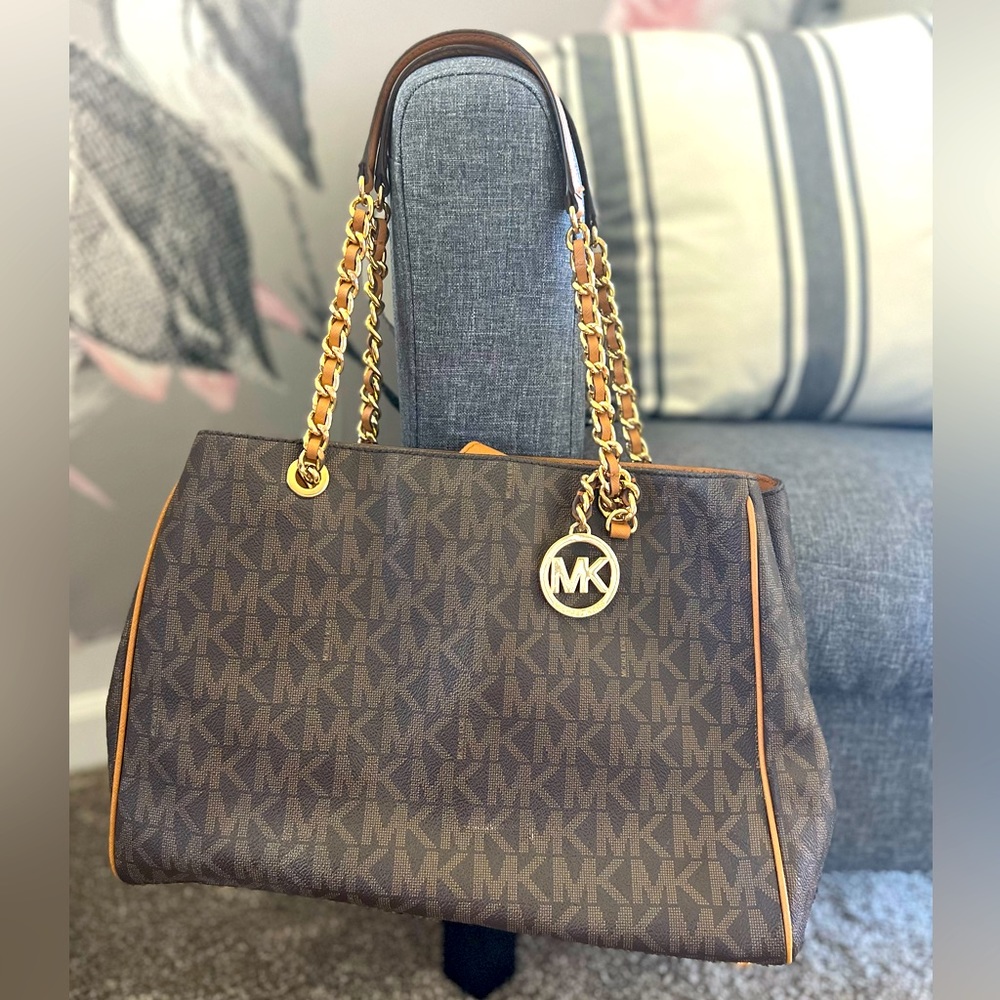 Michael Kors chocolate brown with tan and gold accents. In great condition!